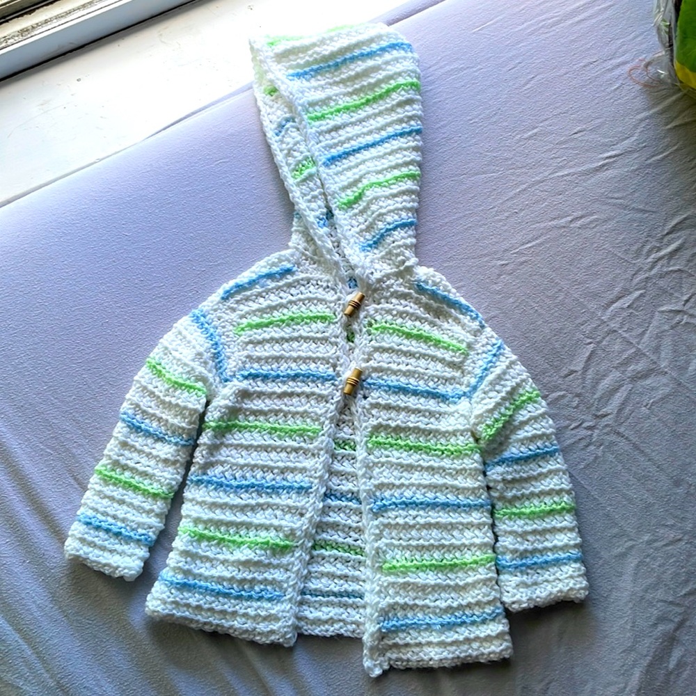 A handmade sweater for babies 3 - 6 months.
